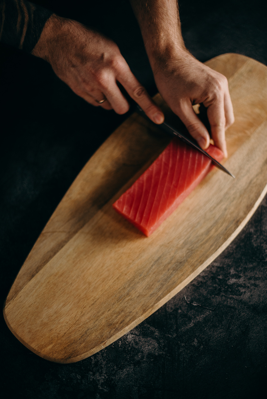 Person Slicing Fish Meat